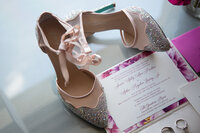 Luxury bridal details featuring sparkling wedding shoes and invitation suite for a Raleigh wedding.
