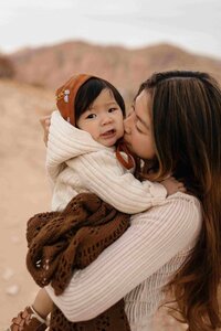 Miami photographer captures tender moment between mother her kid in a natural outdoor setting