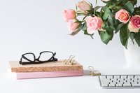 eyeglasses-on-book-beside-rose-and-keyboard-2008143 copy