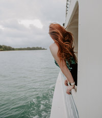 woman leaning out of boat