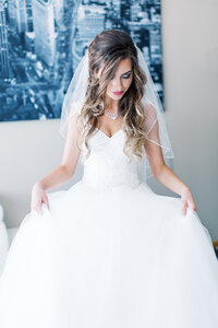 Minnesota bride in her elegant and modern wedding dress showing it off, captured by Toly Dzyuba Photography. 