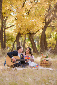 Elopement couple stands by a creek with a mountain in the background in Ouray Colorado