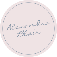 Beige circle with light blue thin circle  inset with script light blue "Alexandra Blair" centered within