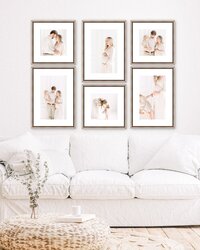 A living room with a white couch and framed photos taken by a Charlotte photographer.