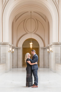 A couple poses for photos at their san francisco city hall elopement