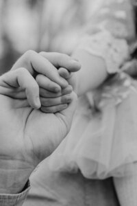 Outdoor family photoshoot in Omaha park during golden hour – capturing candid, heartfelt moments.