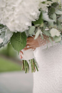Bride holding her elegant white bridal bouquet