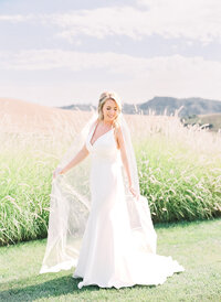 bride standing in gown on lawn at Greengate Ranch