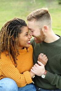 Interracial couple giddy with joy during engagement session