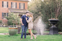 York, Pennsylvania Photographer working with a couples photoshoot in front of a fountain and some pots.