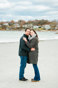 New England beach engagement photos during a sunset coastal session with natural, candid moments.