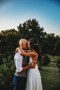 Pregnant woman embracing her belly during a boudoir session in Kansas City