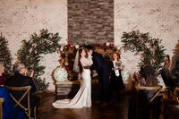 Holiday elopement in side of Steel Magnolia Barn in Murfreesboro with couple kissing after vow exchange