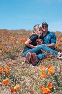 man  woman in field with dog