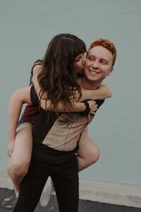 man kissing woman on cheek