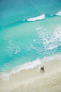 Couple walking on beach in Cancun planned by luxury honeymoon travel agents