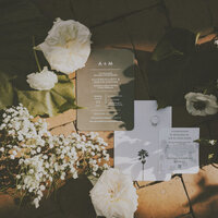 flat lay of wedding stationery and florals