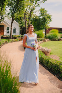 bridesmaid walking down aisle at dallas texas wedding venue