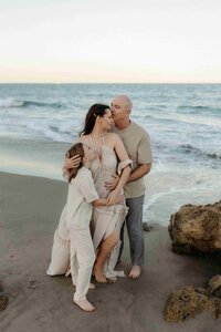 Miami photographer captures tender moment between parents and daughters in a natural outdoor setting