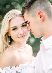 Couple with mans head touching womans