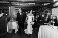 A couple enter their wedding reception captured with flash by Candid Wedding Photographer. 