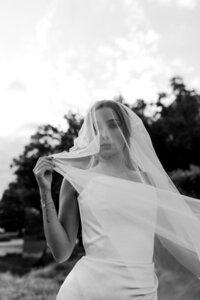 bride adjusts her veil