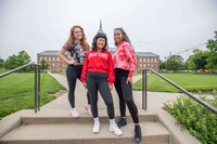 three models wearing college game day gear in black and red