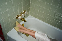 woman wearing heels in a bath tub