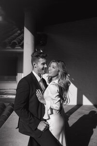man and woman smiling and embracing