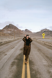 woman stands in road