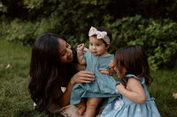 grandma kissing granddaughters cheek