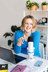 Maddie talking into podcast microphone