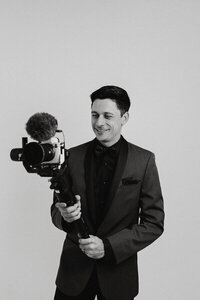 Corey Combs holding a camera shooting videos