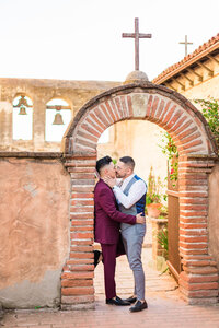 gay couple kisses in golden sunlight