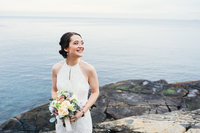Bride standing on rocks