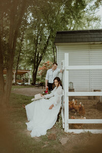 Bride and groom portrait on the farmhouse porch at The Kester Homestead — Syracuse and Central New York documentary wedding photography.
