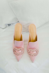 event design details luxury pink manolo blahnik wedding shoes on a grey marble backdrop