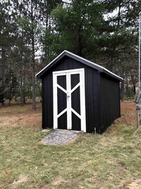 black shed with white trim