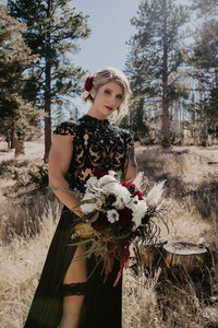 bride in black in forest