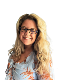 Smiling blonde woman wearing glasses and blue patterned dress smiles at camera