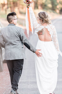 bridal couple embracing in a grass field