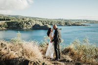 bride and groom embracing near ocean