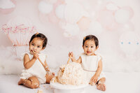 Little baby ellis smashing her cake during her cake smash photoshoot with auckland photographer michelle kelly.