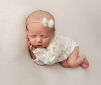 Newborn photo of a baby wrapped in green in an Erie Pa studio