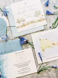 tropical wedding invitation suite with custom watercolor map