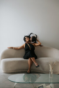 man kissing woman's neck on couch