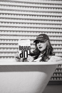 Sasha in bathtub reading book Brand Up