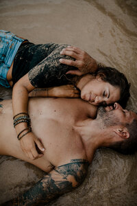 couple laying in the sand