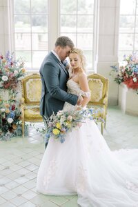 Bride and Groom hugging each other while standing next to each other