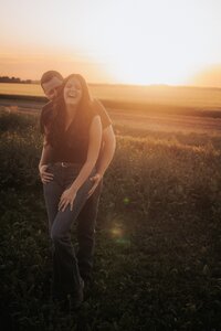 family sitting together in the grass and bushes in the county of newell alberta